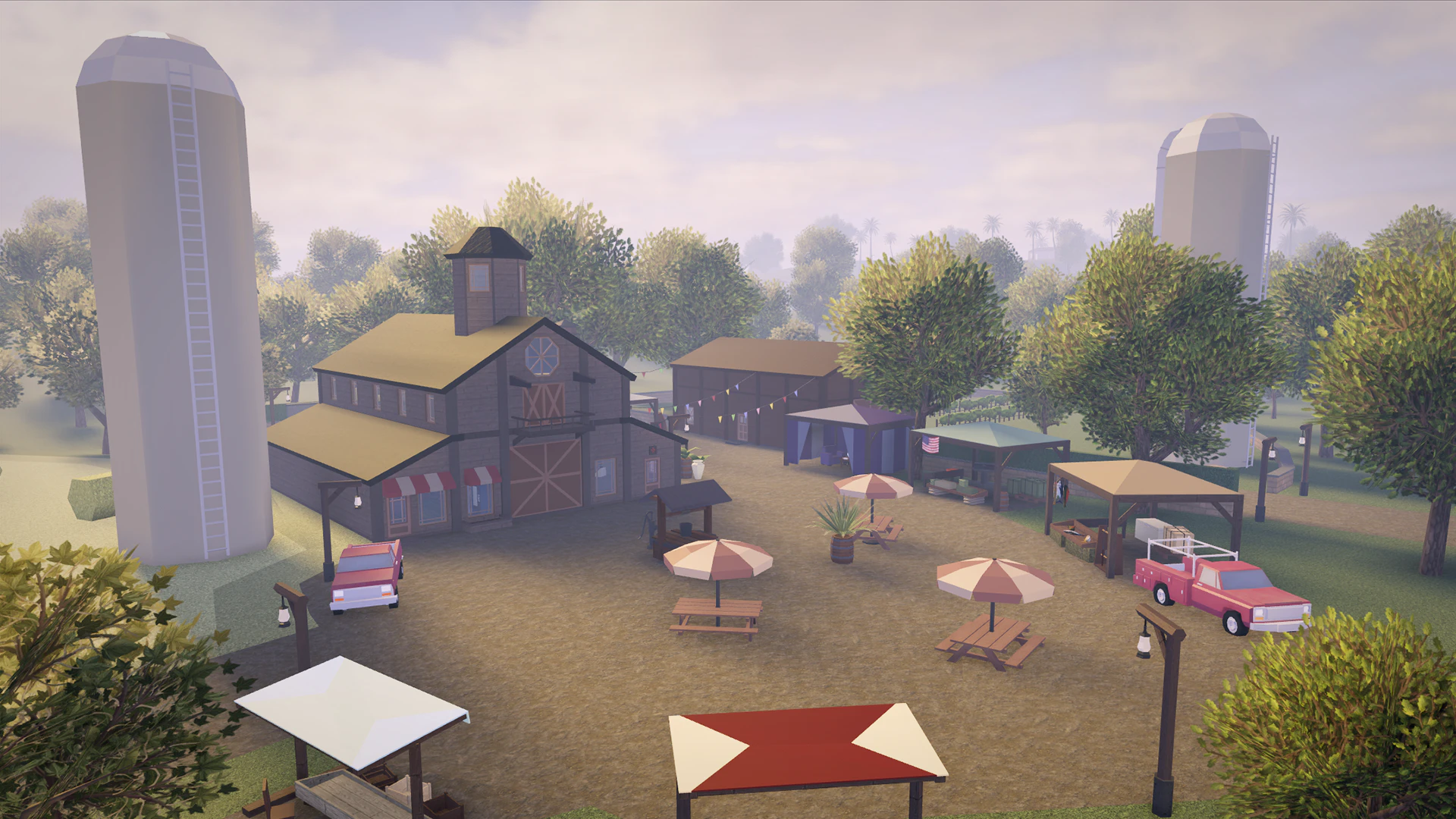 Farm market with a barn, silos and picnic umbrellas