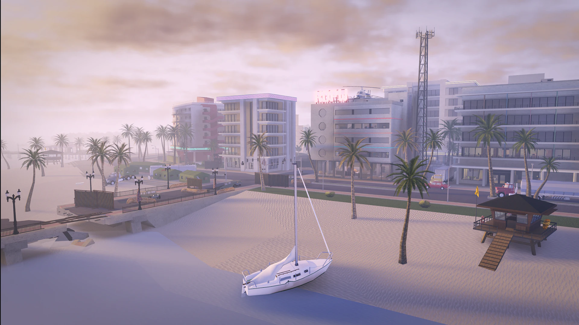 Marina with a sailboat in front of beachfront hotels