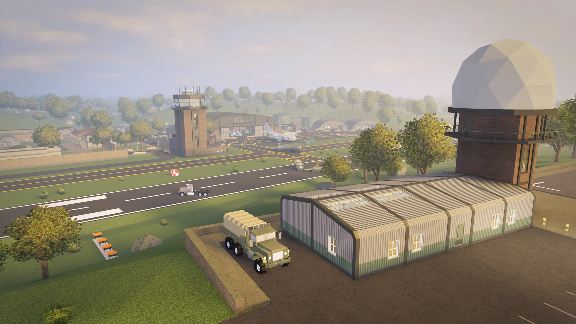 Military airfield with a runway, hangar, control tower and radar dome