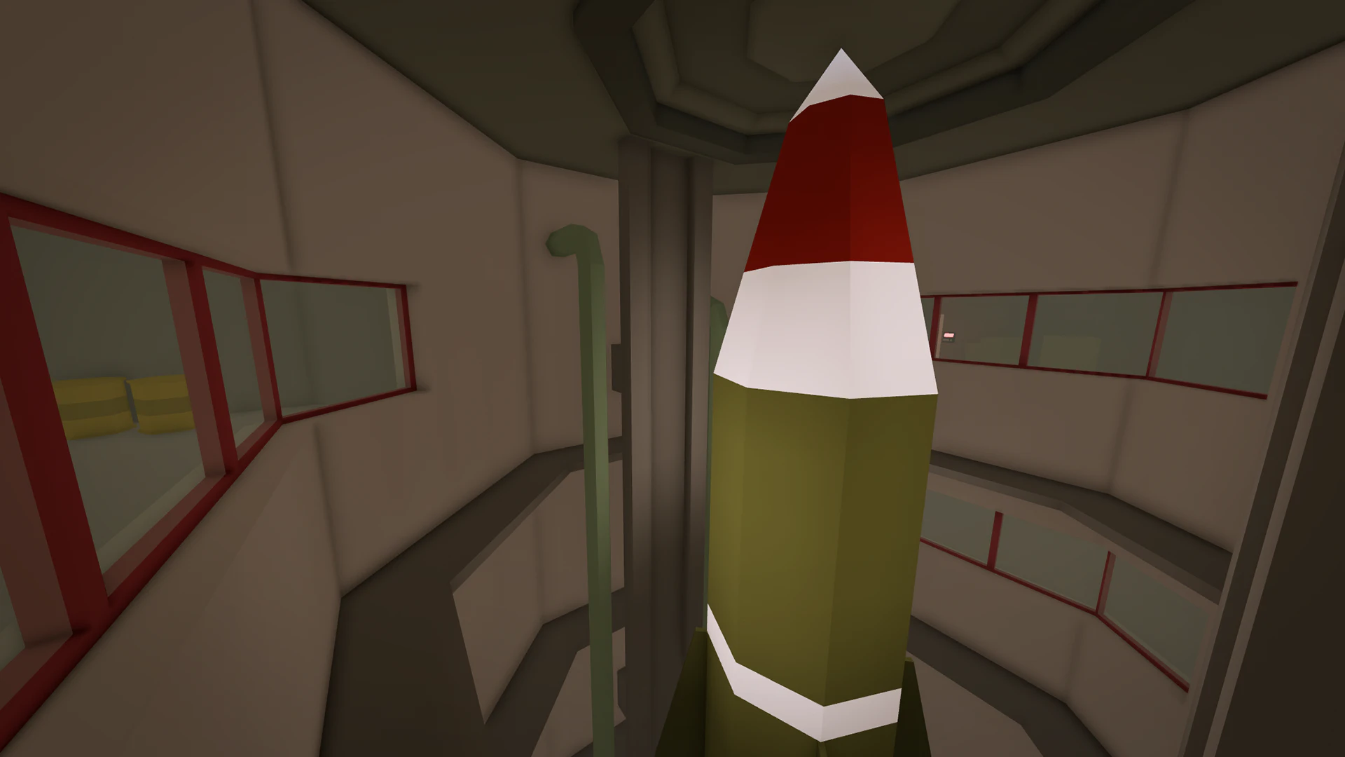 Interior of a missile silo with a red and white missile